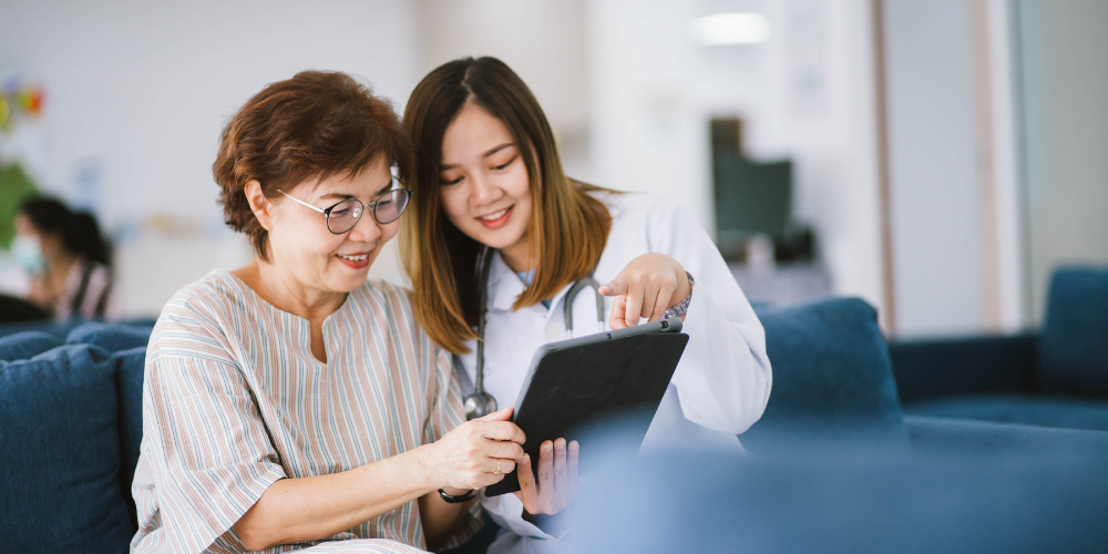 Healthcare worker and patient on tablet